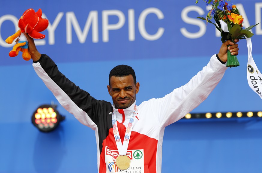 Switzerland's gold medal winner Tadesse Abraham celebrates during the medal ceremony for the men's half marathon at the European Athletics Championships in Amsterdam, the Netherlands, Sunday, July 10, ...