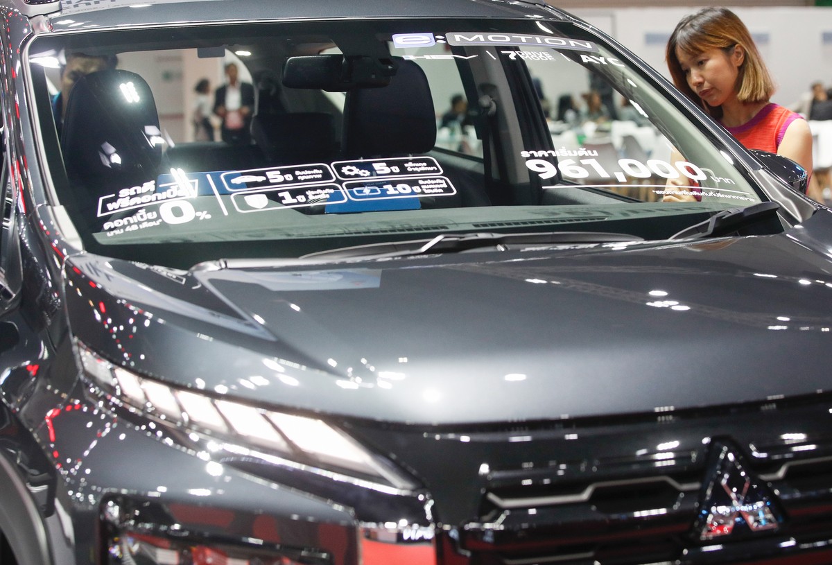 epa11566721 A visitor inspects a Mitsubishi car displayed at the Big Motor Sale 2024 automobile showcasing event in Bangkok, Thailand, 27 August 2024. Thailand auto market continues to slow down with  ...