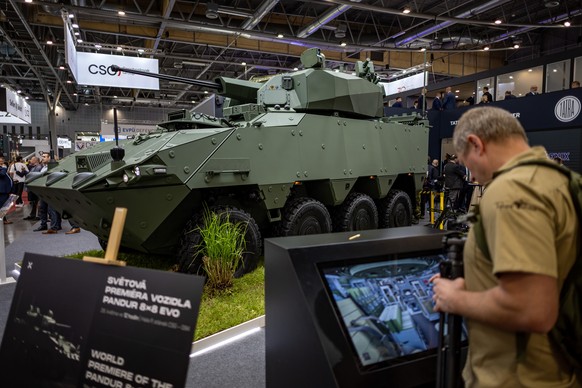 epa12140978 A visitor stands next to the Pandur 8x8 EVO by CSG on the opening day of the international defense and security technologies fair IDET, in Brno, Czech Republic, 28 May 2025. Over 650 exhib ...