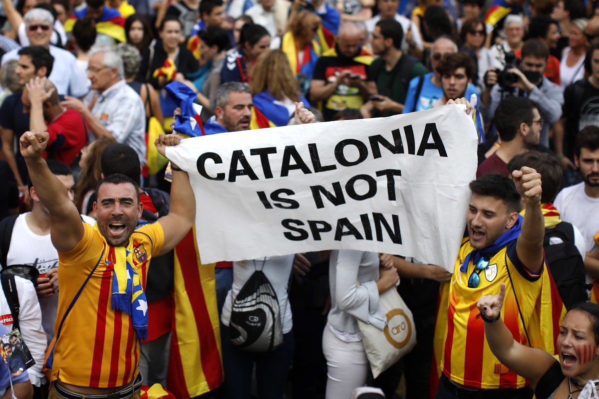 People react as they celebrate the unilateral declaration of independence of Catalonia outside the Catalan Parliament, in Barcelona, Spain, Friday, Oct. 27, 2017. Catalonias' regional Parliament  ...