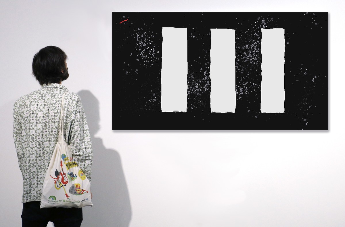 epa07215743 An Art Basel patron looks at 'Light Shade 7' by Bridget Riley during Art Basel in Miami, Florida, USA, 07 December 2018. Art Basel represents over 250 art galleries onsite at the ...