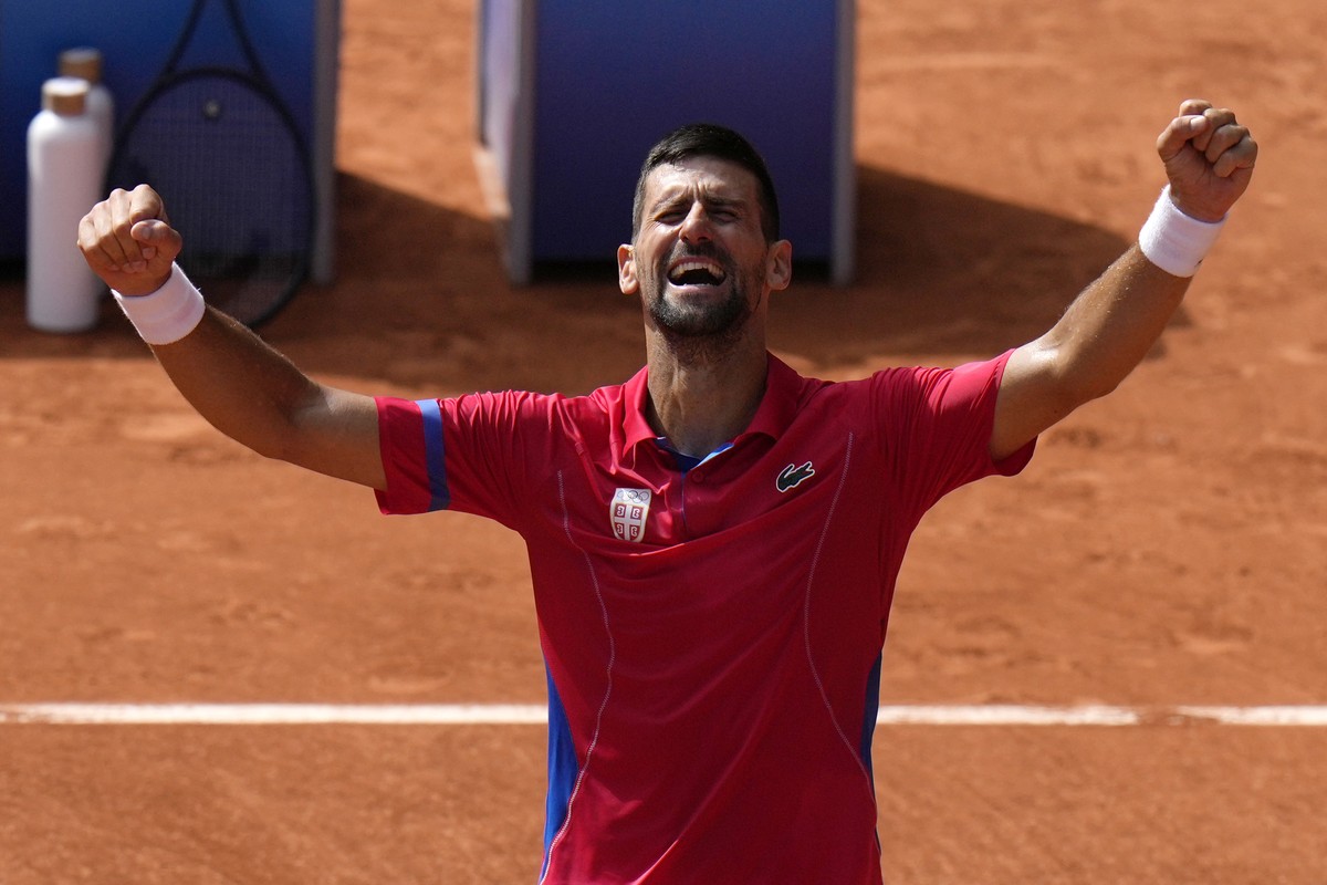 Serbia's Novak Djokovic reacts after defeating Spain's Carlos Alcaraz during the men's singles tennis final at the Roland Garros stadium during the 2024 Summer Olympics, Sunday, Aug. 4, ...