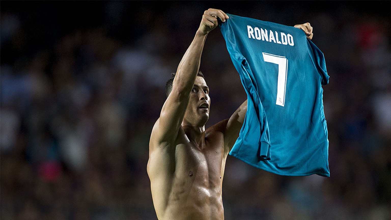 Real Madrid&#039;s Portuguese forward Cristiano Ronaldo takes off his jersey to celebrate his goal during the first leg of the Spanish Supercup football match between FC Barcelona and Real Madrid CF a ...