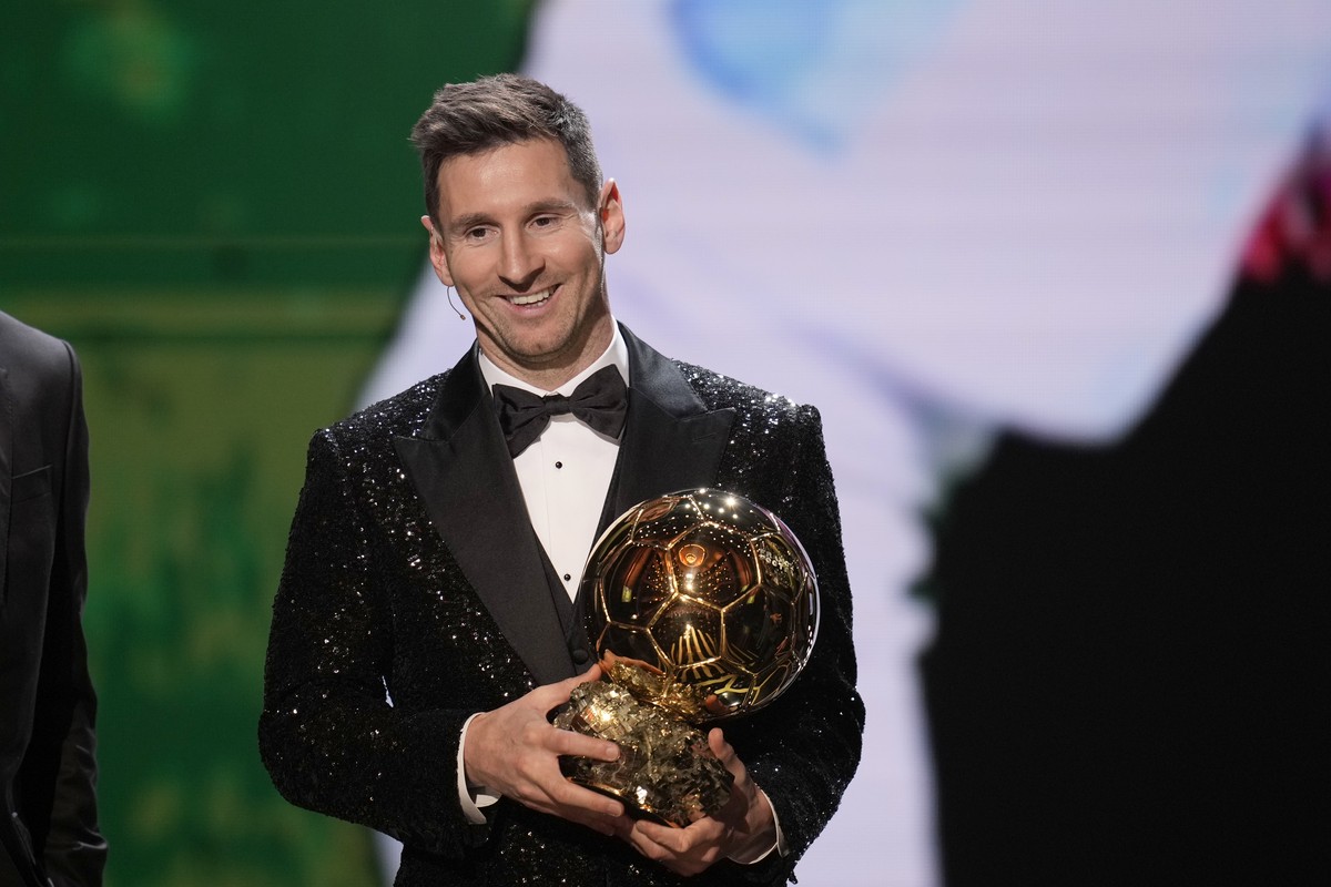 PSG player Lionel Messi reacts after winning the 2021 Ballon d'Or trophy during the 65th Ballon d'Or ceremony at Theatre du Chatelet, in Paris, Monday, Nov. 29, 2021. Messi won the Ballon d& ...