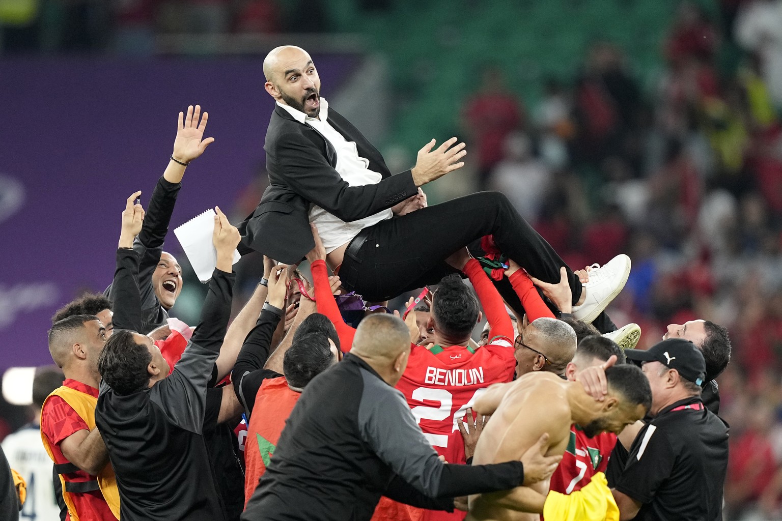 Morocco&#039;s head coach Walid Regragui is thrown in the air by players after the World Cup quarterfinal soccer match between Morocco and Portugal, at Al Thumama Stadium in Doha, Qatar, Saturday, Dec ...
