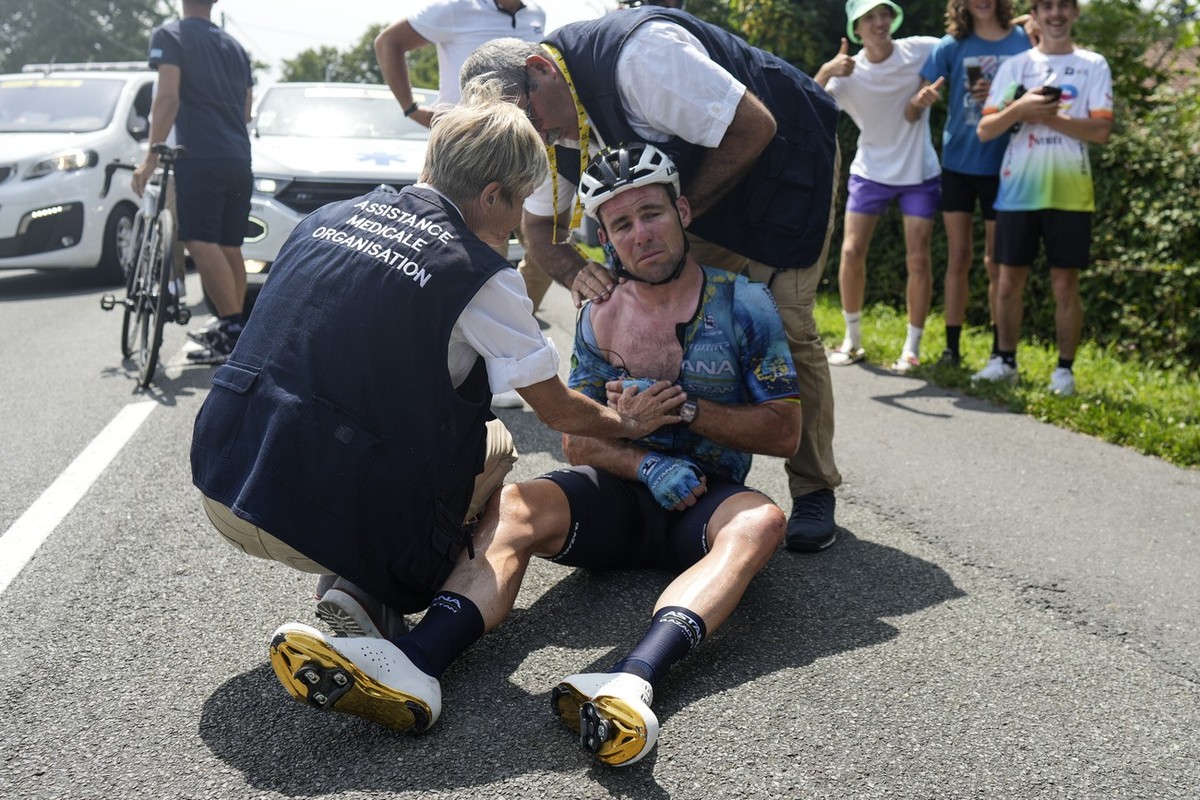 Britain's Mark Cavendish receives medical assistance after crashing during the eighth stage of the Tour de France cycling race over 201 kilometers (125 miles) with start in Libourne and finish in ...