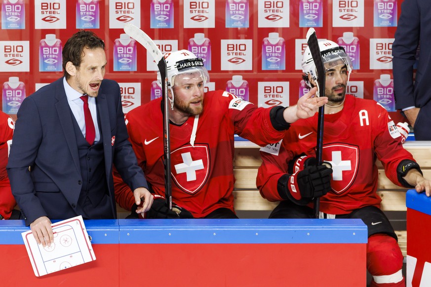 Patrick Fischer, head coach of Switzerland national ice hockey team, and Switzerland&#039;s forward Tanner Richard #71 react next to Switzerland&#039;s forward Andres Ambuehl, during the IIHF 2023 Wor ...