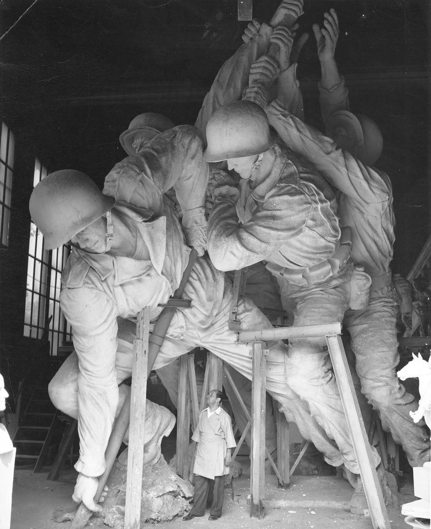 Sculptor Felix de Weldon working on the plaster model of the US Marine Corps War Memorial, c. 1954. His artwork is located just outside of Arlington National Cemetery, in Virginia.