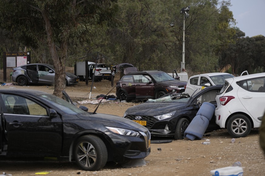 Damaged cars are scattered in the area of the rave party site near the Kibbutz Re&#039;im, close to the Gaza Strip border fence, on Tuesday, Oct.10, 2023. Israel&#039;s rescue service Zaka said parame ...