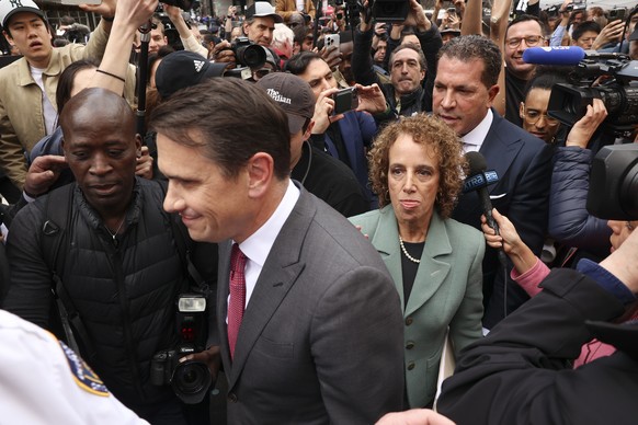 The defense team of former President Donald Trump, from left, Todd Blanche, Susan Necheles, center, and Joseph Tacopina, top right, leave Manhattan Criminal Court, Tuesday, April 4, 2023, in New York...