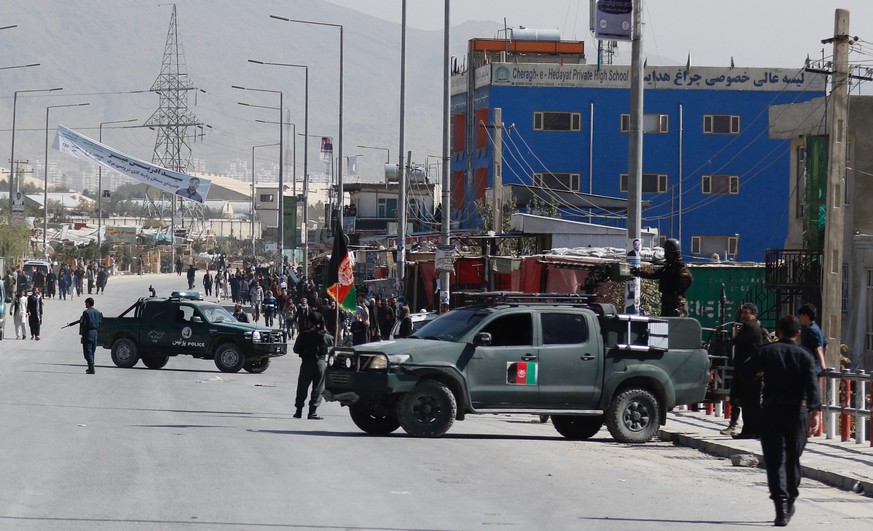 epa07106341 Afghan security personnel secure the area after a mine explosion which was deployed in the entrance gate of a polling center in downtown Kabul, Afghanistan, 20 October 2018. At least two p ...