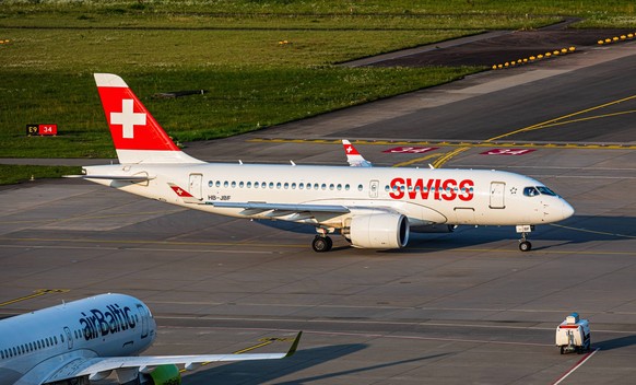 Swiss International Airlines Zurich, Switzerland, 4th Aug 2024: A Swiss International Airlines Airbus A220-100 taxis to the runway at Zurich Airport. Registration HB-JBF. An Air Baltic Airbus A220 is  ...