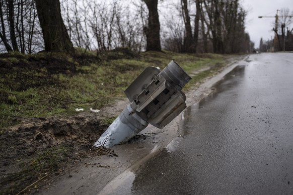 A rocket is buried in the ground in Bucha, Ukraine, Sunday, April 3, 2022. Ukrainian troops are finding brutalized bodies and widespread destruction in the suburbs of Kyiv, sparking new calls for a war crimes investigation and sanctions against Russia. (AP Photo/Rodrigo Abd)