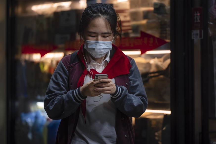 epa09481246 A school girl uses her phone on the street in Shanghai, China, 22 September 2021. Douyin, China&#039;s version of the famous short video app TikTok, will limit the use of the platform for  ...