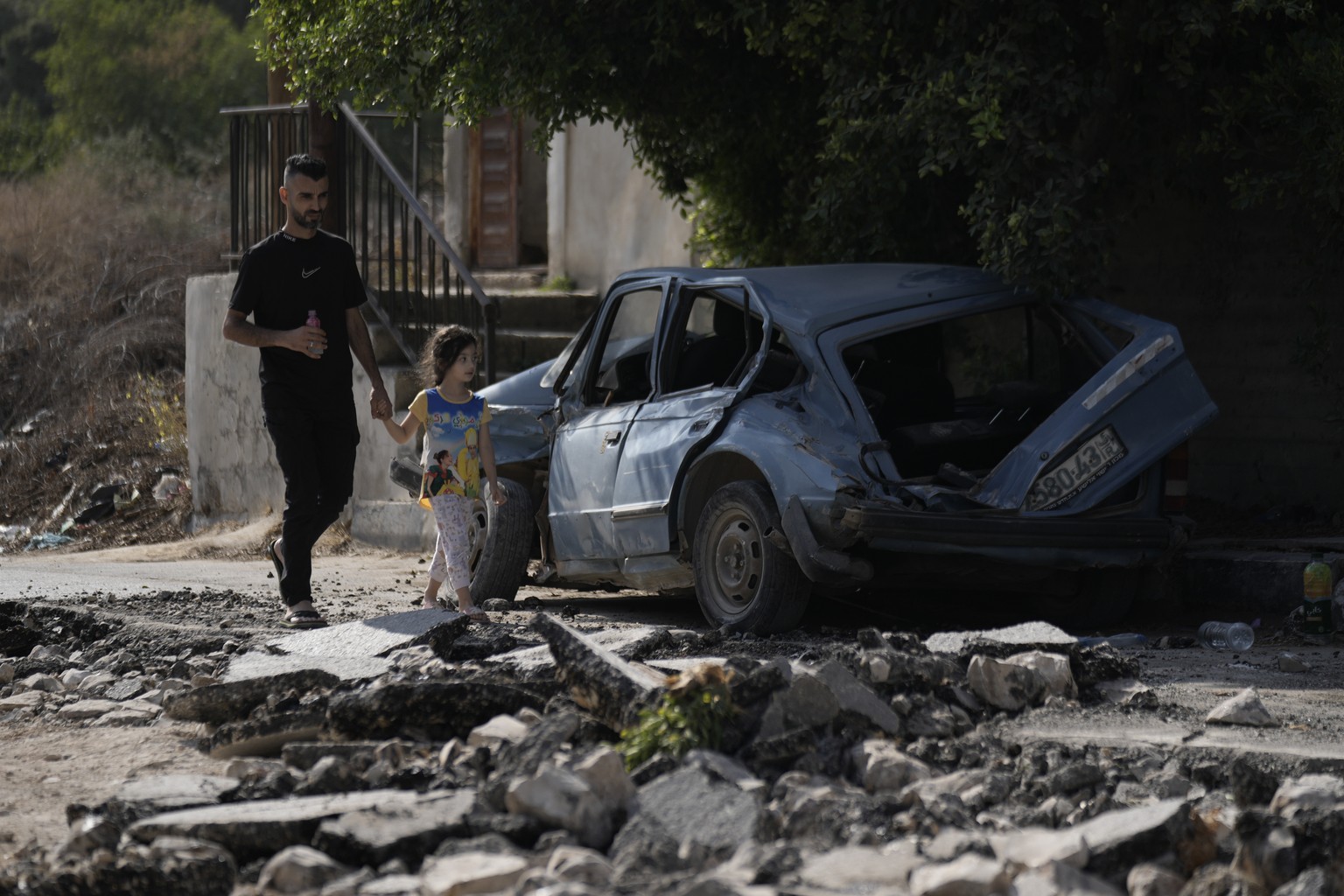 Palestinians ride a scooter through a street destroyed in an Israeli military raid on Jenin, West Bank, Wednesday, Nov. 1, 2023. (AP Photo/Majdi Mohammed)