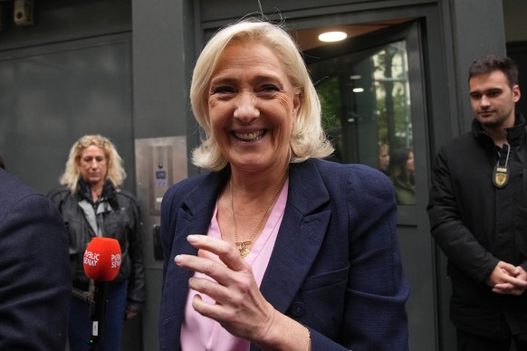 French far right leader Marine Le Pen smiles following a meeting at the National Rally party headquarters, after France&#039;s prime minister Sebastien Lecornu resigned plunging the country into a dee ...