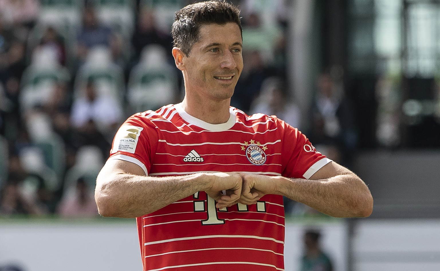 Bayern&#039;s Robert Lewandowski celebrates after scoring during the German Bundesliga soccer match between VfL Wolfsburg and Bayern Munich in Wolfsburg, Germany, Saturday, May 14, 2022. (Swen Pfoertn ...