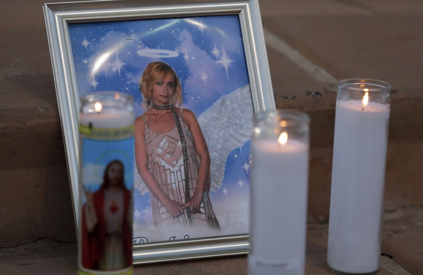 Candles are placed next to a photograph of cinematographer Halyna Hutchins during a vigil in her honor in Albuquerque, N.M. Saturday, Oct. 23, 2021. Hutchins was fatally shot on Thursday, Oct. 21, aft ...