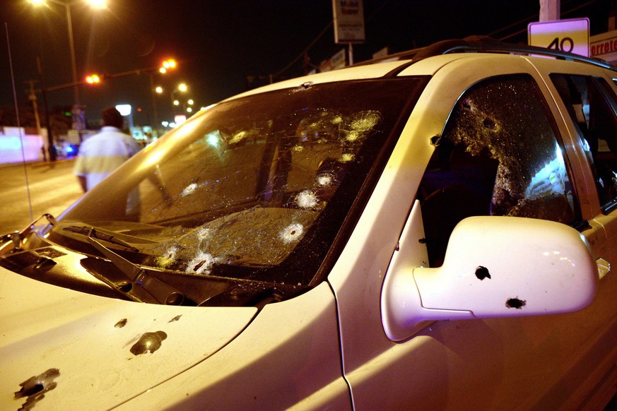 epa05863754 A picture made available on 22 March 2017 shows the car with the bullets impact in the area of the attack against the commander of the municipal police of Culiacan, Jesus Alberto Vargas, i ...