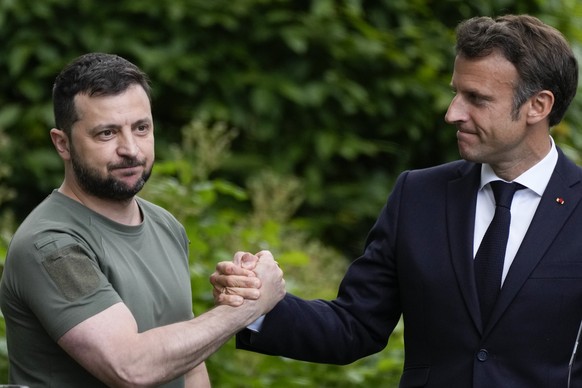 Ukraine President Volodymyr Zelenskyy, left, and France&#039;s President Emmanuel Macron shake hands at the end of a press conference at the Mariyinsky Palace in Kyiv, Ukraine, Thursday, June 16, 2022 ...