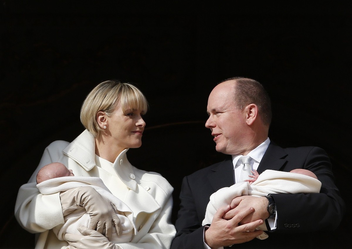 Princess Charlene and Prince Albert appear on a palace balcony, each holding a newborn baby swaddled in white in Monaco, Wednesday, Jan. 7, 2015. The hereditary heir Prince Jacques and his older siste ...