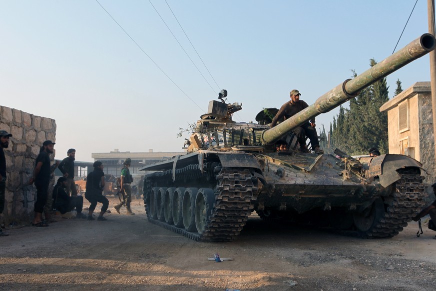 Rebel fighters ride a tank in an artillery academy of Aleppo, Syria, August 6, 2016. REUTERS/Ammar Abdullah