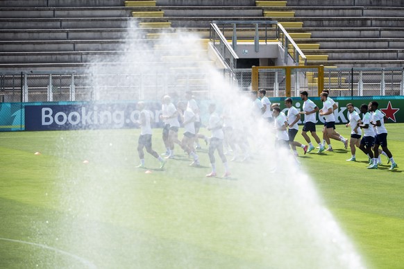 epa09292997 A water jet sprays the soccer field in front of the Switzerland&#039;s soccer players during a training session for the Euro 2020 soccer tournament at the Tre Fontane sports centre, in Rom ...
