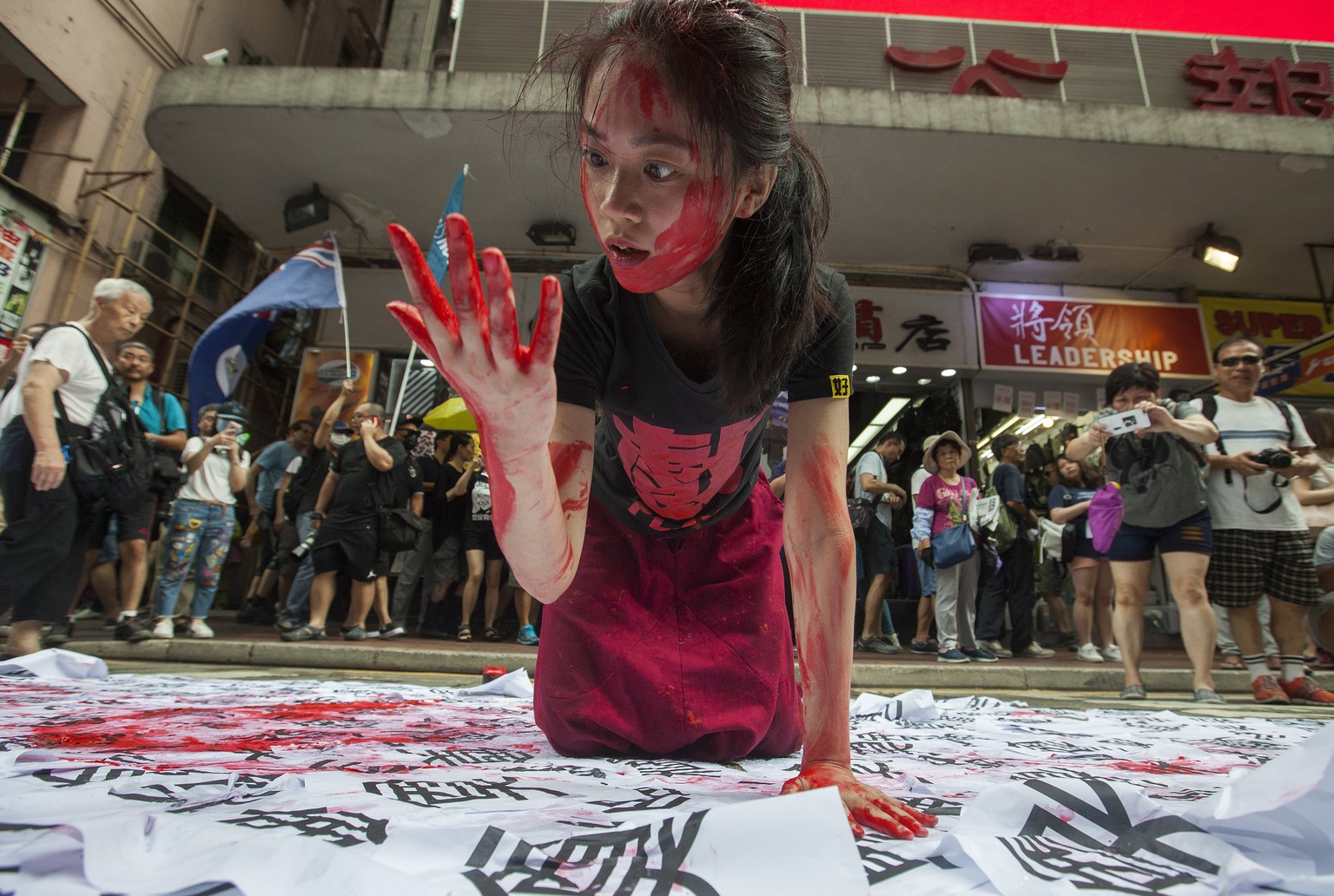 epa06059757 A pro-democracy performance artist acts on the theme of Chinese totalitarian rule in the streets of Hong Kong on the 20th anniversary of the handover of sovereignty from Britain to China o ...