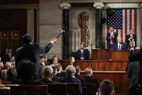 epa11941181 Democratic Congressman Al Green of Texas (L) shouts out as US President Donald Trump addresses to a joint session of the United States Congress at the US Capitol in Washington, DC, USA, on ...