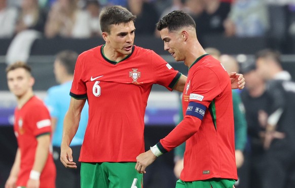 epa11451288 Joao Palhinha (L) and Cristiano Ronaldo of Portugal during the UEFA EURO 2024 Round of 16 soccer match between Portugal and Slovenia, in Frankfurt Main, Germany, 01 July 2024. EPA/MOHAMED  ...