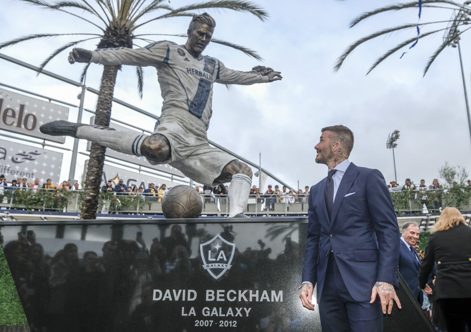 Former LA Galaxy MLS soccer midfielder David Beckham looks at a statue of himself at Legends Plaza in front of Dignity Health Sports Park in Carson, Calif., Saturday, March 2, 2019. (AP Photo/Ringo H. ...