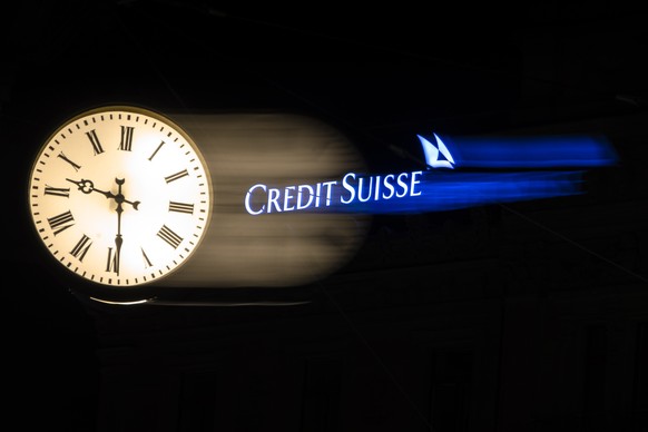 epa10531016 The illuminated logo of Swiss bank Credit Suisse is seen behind a clock at the bank&#039;s headquarters at Paradeplatz in Zurich, Switzerland, 18 March 2023. Shares of Credit Suisse lost m ...