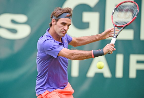 HALLE, GERMANY - JUNE 15: Roger Federer of Switzerland plays a backhand in his match against Philipp Kohlschreiber of Germany during day one of the Gerry Weber Open at Gerry Weber Stadium on June 15,  ...