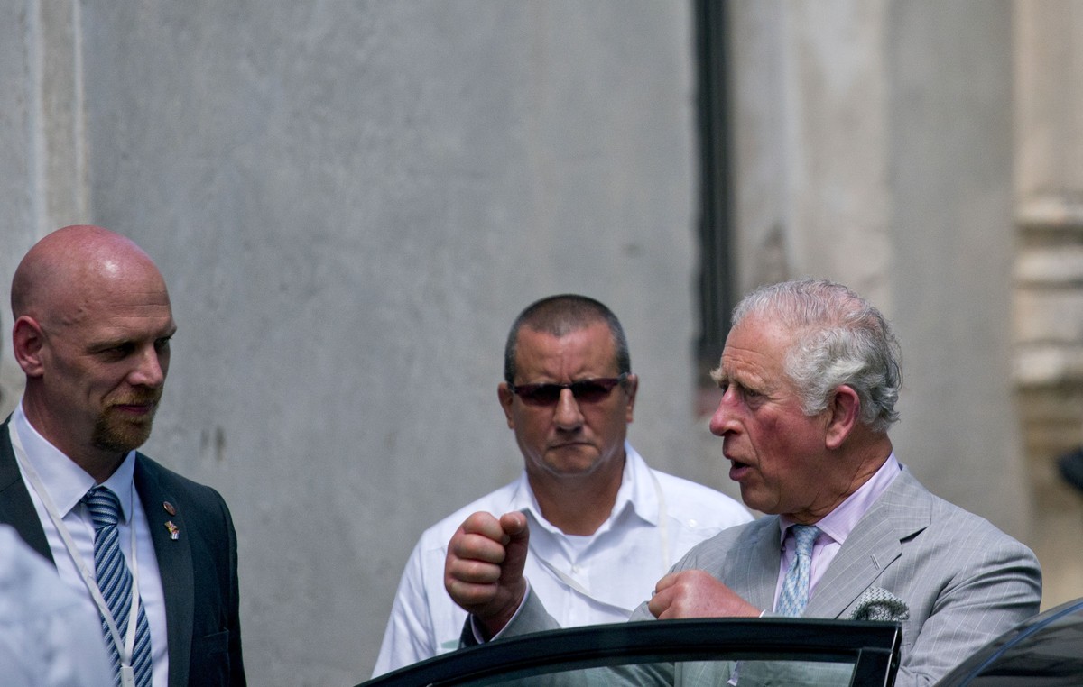 Britain's Prince Charles, the Prince of Wales, holds up his fists as he talks with one of his bodyguards after visiting a gym boxing during his official trip to Cuba, in Havana, Cuba, Sunday, Mar ...