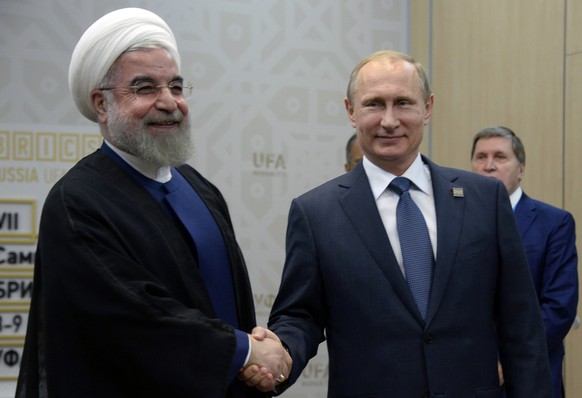 Russian President Vladimir Putin, right, shakes hands with President of the Islamic Republic of Iran Hassan Ruhani in Ufa, Russia, Thursday, July 9, 2015. (Alexander Nemenov/Pool photo via AP)