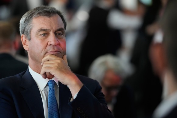 Bavarian State Governor Markus Soeder listens to CDU Secretary General Carsten Linnemann, left, and German Vice Chancellor and Finance Minister Lars Klingbeil during the Social Democrats Partys ' ...