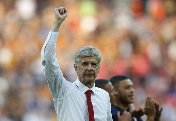 FILE - In this Saturday, May 17, 2014 file photo, Arsenal's manager Arsene Wenger punches the air in celebration of their win against Hull City at the end of their English FA Cup final soccer mat ...