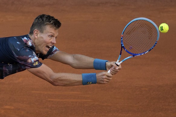 Tomas Berdych of the Czech Republic returns a shot to John Isner of the U.S. during the Madrid Open Tennis tournament in Madrid, Spain, Friday, May 8, 2015. (AP Photo/Paul White)