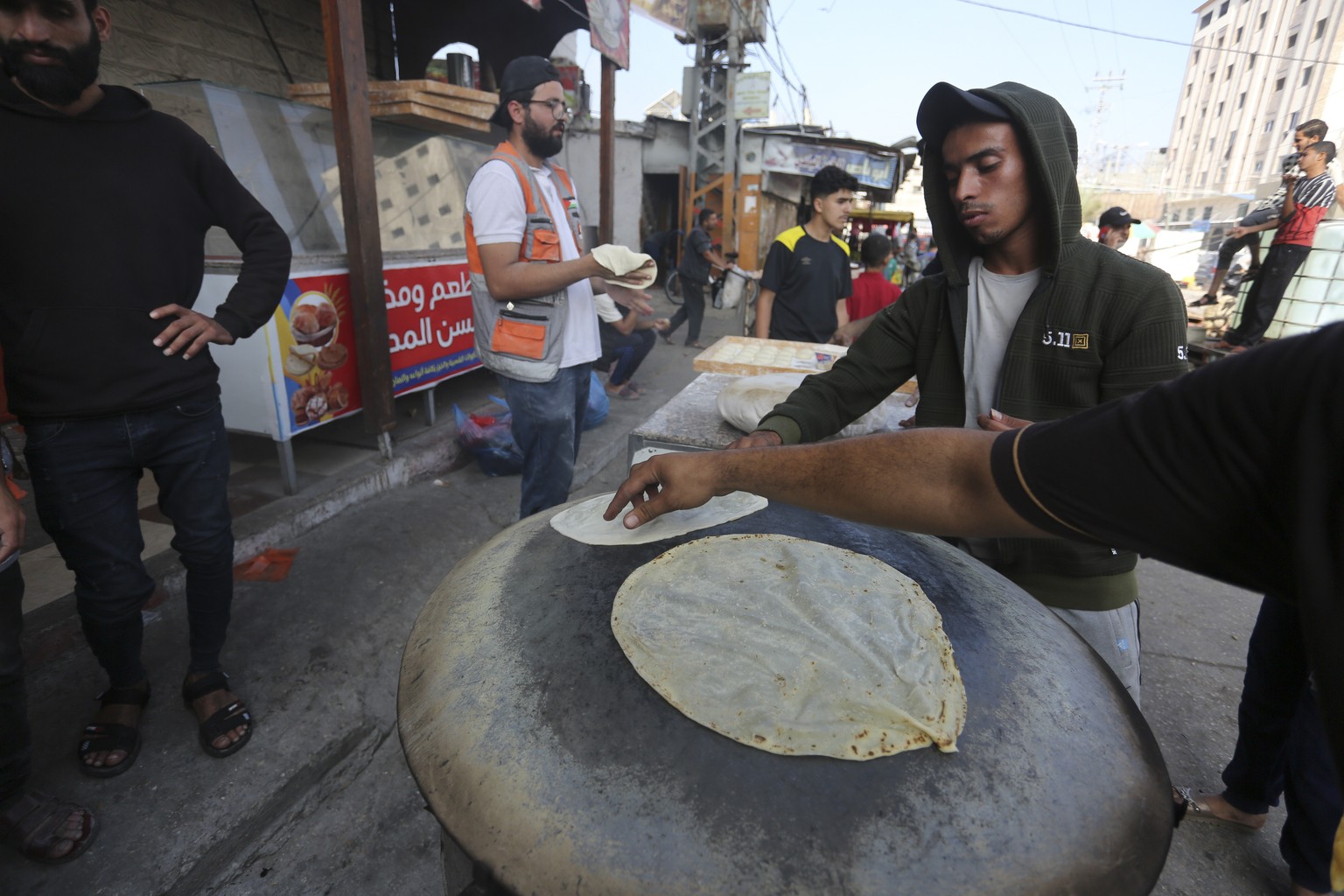 Palestinians bake bread on a street in Rafah during the ongoing Israeli bombardment of the Gaza Strip on Wednesday, Nov. 8, 2023. (AP Photo/Hatem Ali)