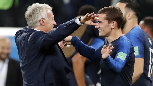 epa06879133 Antoine Griezmann of France (R) reacts with France's coach Didier Deschamps after winning the FIFA World Cup 2018 semi final soccer match between France and Belgium in St.Petersburg, Russi ...