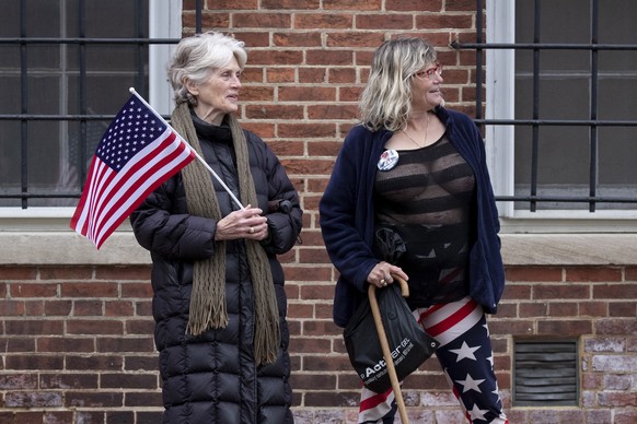 epa08373574 People that voted for US President Donald J. Trump, Ruth Brown (L) and Chari Rae McLean (R), show their support in calling for the Maryland state government to reopen during the coronaviru ...