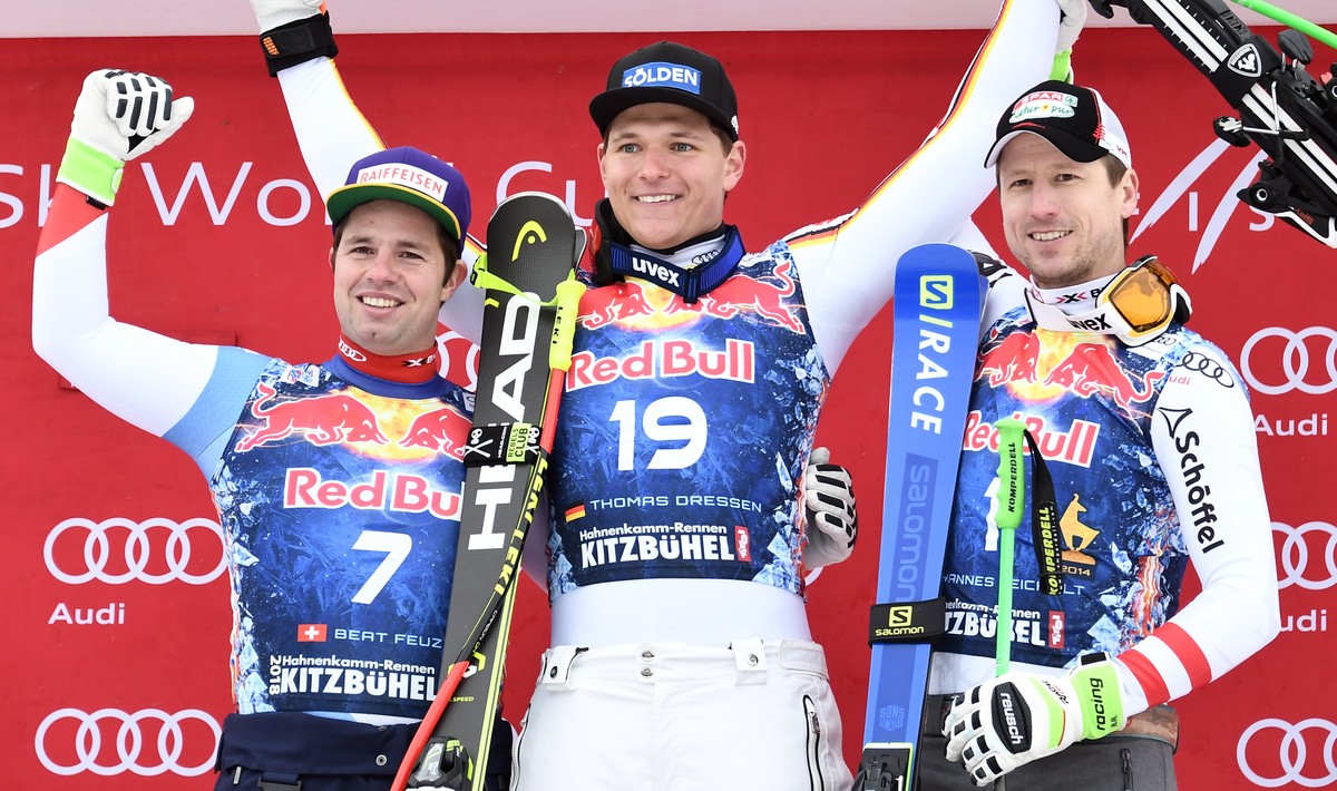 epa06457070 Second placed Beat Feuz of Switzerland (L), winner Thomas Dressen of Germany (C) and third placed Hannes Reichelt of Austria (R) react on the podium after the Men's Downhill race of t ...
