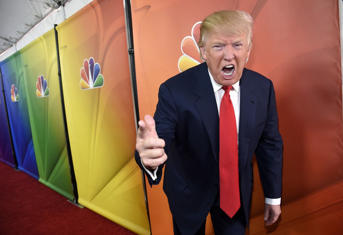 In this Jan. 16, 2015 photo, Donald Trump, host of the television series "The Celebrity Apprentice," mugs for photographers at the NBC 2015 Winter TCA Press Tour in Pasadena, Calif. The skyl ...