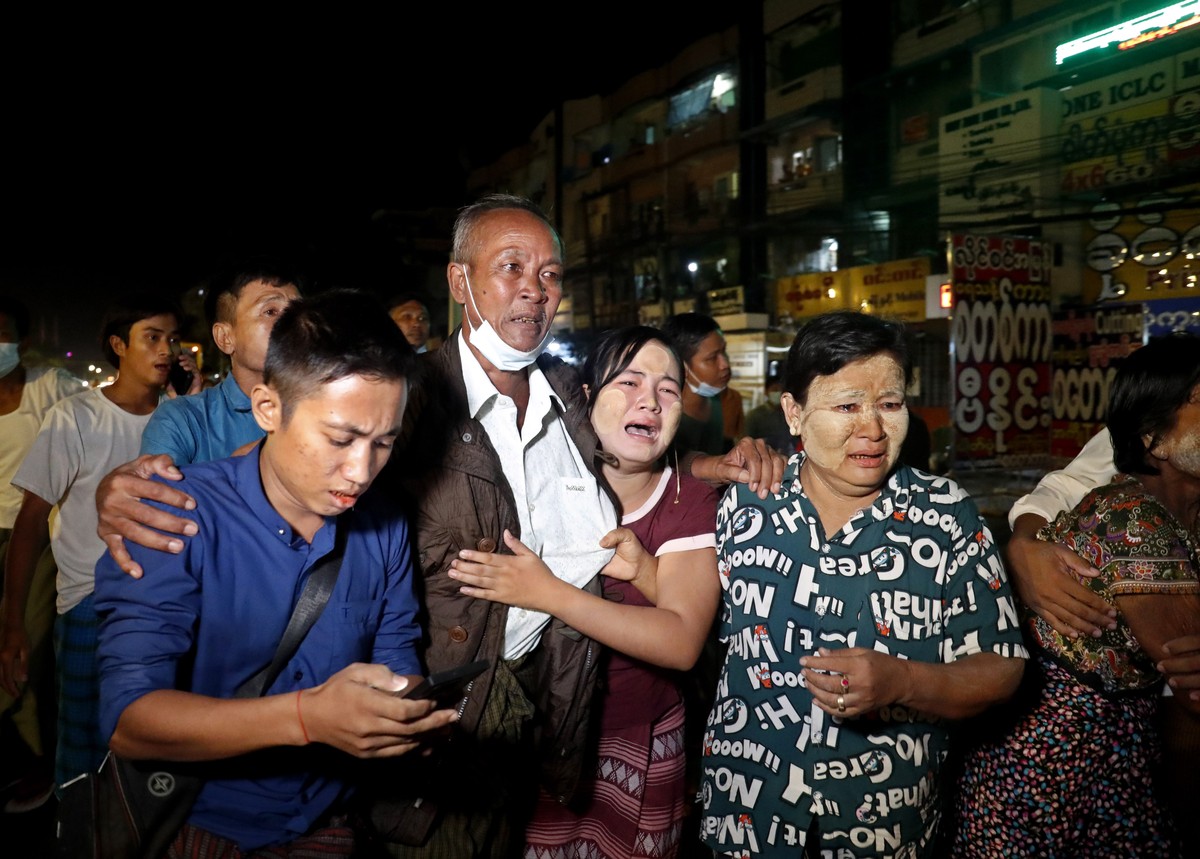 epa09530203 A released man (2-L) meets with his family members outside the Insein prison in Yangon, Myanmar, 18 October 2021. Myanmar's junta chief Min Aung Haling announced the released of over  ...
