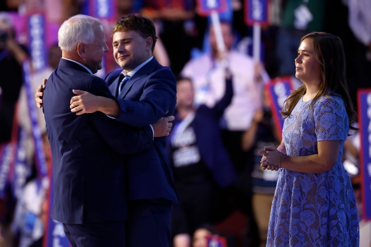 CHICAGO, ILLINOIS - AUGUST 21: Democratic vice presidential candidate Minnesota Gov. Tim Walz embraces his son Gus Walz (C) as his daughter Hope Walz (R) looks on after speaking on stage during the th ...