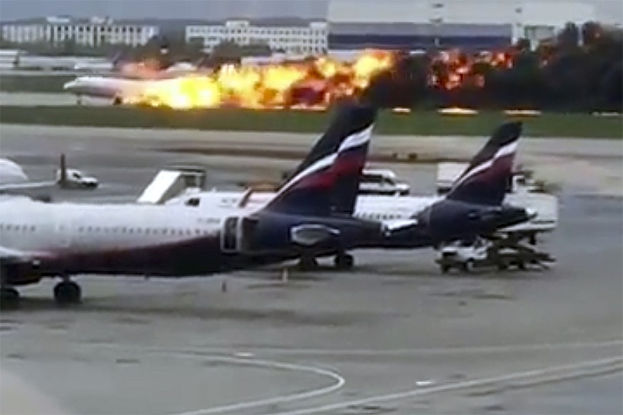 This image taken from video provided by Instagram user @artempetrovich, shows the SSJ-100 aircraft of Aeroflot Airlines on fire during an emergency landing in Sheremetyevo airport in Moscow, Russia, S ...