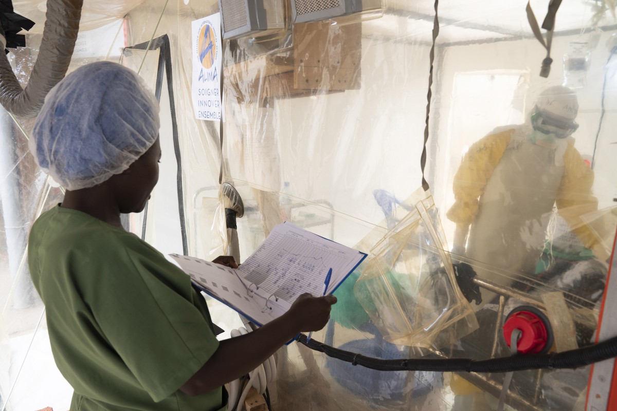 epa07788728 A handout image dated 23 June 2019 and made available by the World Health Organization, WHO, on 23 August 2019 showing Health workers inside a 'CUBE' talking to an Ebola patient, ...