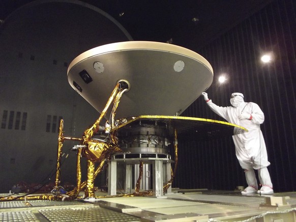 In this 2015 photo made available by NASA, a technician prepares the InSight spacecraft for thermal vacuum testing in its &quot;cruise&quot; configuration for its flight to Mars, simulating the condit ...