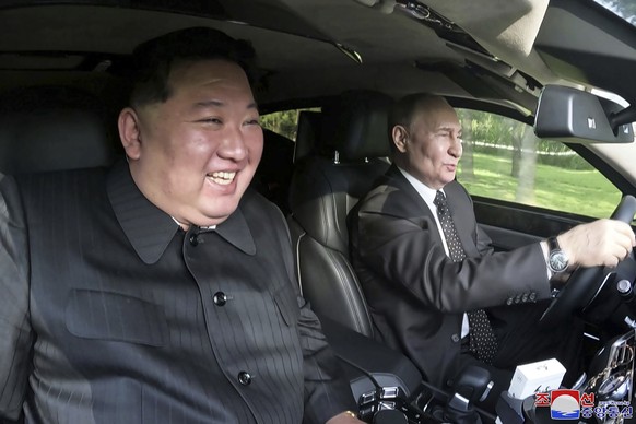 FILE - In this photo provided by the North Korean government, Russia&#039;s President Vladimir Putin, right, drives a car with North Korean leader Kim Jong Un sitting in front passenger seat at a gard ...