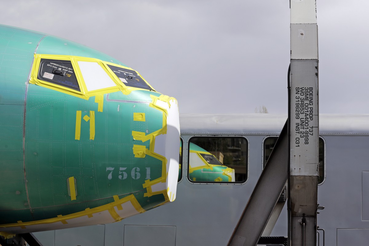 FILE - In this April 9, 2019, file photo the front of a Boeing 737 fuselage, eventually bound for Boeing's production facility in nearby Renton, Wash., sits on a flatcar rail car and is reflected ...